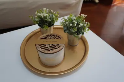 a plate with two vases and flowers on a table at O Ferrador in Caldas de Reis