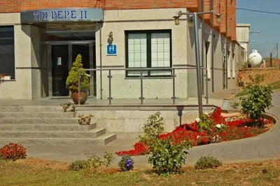 a building with some flowers in front of it at Hostal Tio Pepe II in Bembibre