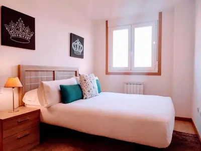 a bedroom with a large white bed and a window at Monforte in Monforte de Lemos