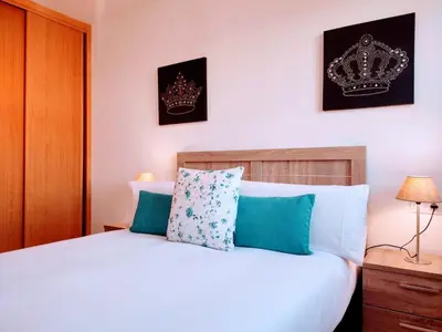 a bedroom with a bed with two crowns on the wall at Monforte in Monforte de Lemos