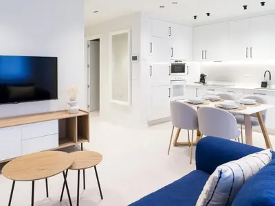 a kitchen and living room with a table and chairs at Loft América 32 in Melide