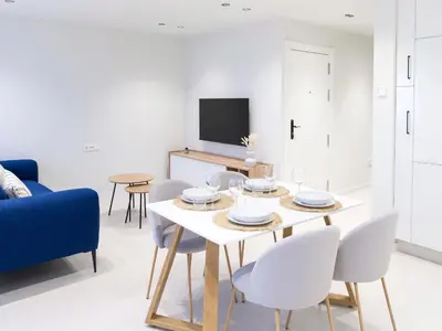 a living room with a table and chairs and a tv at Loft América 32 in Melide