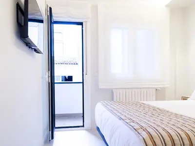 a bedroom with a bed and a sliding glass door at Loft América 32 in Melide