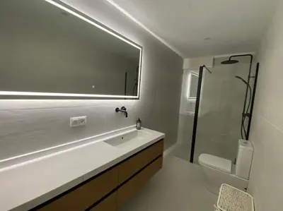 a bathroom with a sink and a shower and a toilet at A Terraza in Puentedeume