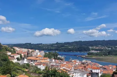 a view of a city with a river and buildings at A Terraza in Puentedeume