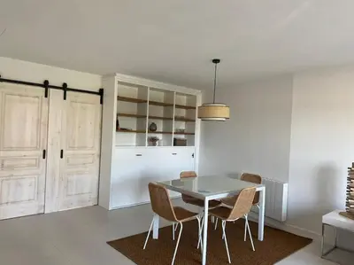 a white dining room with a table and chairs at A Terraza in Puentedeume