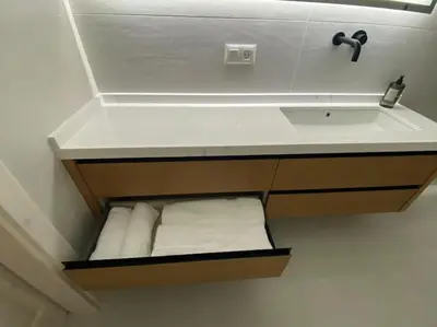 a bathroom with a sink and a bunch of towels at A Terraza in Puentedeume