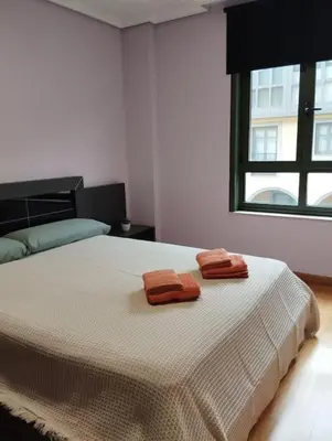 a bedroom with a bed with two towels on it at VUT Mencía in Ponferrada