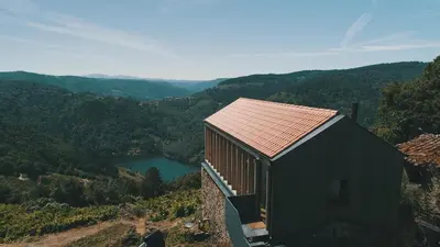 a small house on a hill with a view of a lake at Geodesic Domes with Best Views in Ribeira Sacra in Pincelo
