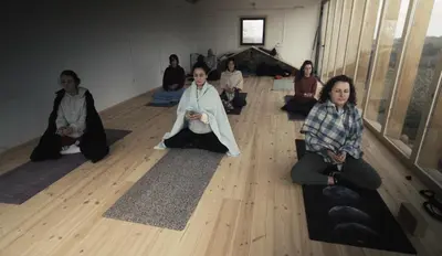 a group of women sitting on the floor in a room at Geodesic Domes with Best Views in Ribeira Sacra in Pincelo