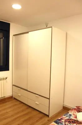 a large white cabinet in the corner of a room at A Ledicia no camiño in Melide
