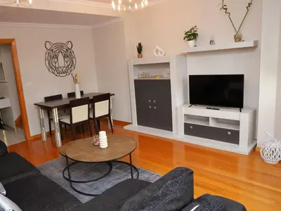 a living room with a table and a television at Arel Dúplex in Lugo