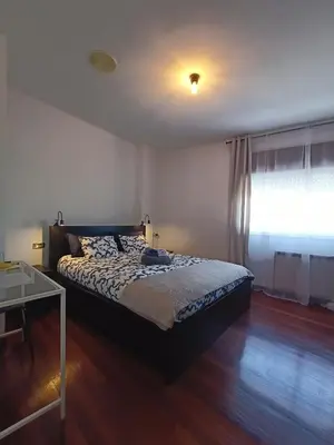a bedroom with a bed and a window at Cesuresrooms1 in Puentecesures