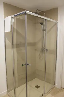 a shower with a glass door in a bathroom at XELIÑA c in A Estrada