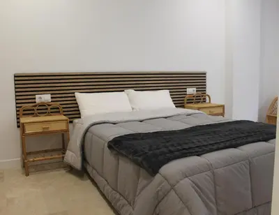 a bedroom with a large bed and two night stands at XELIÑA c in A Estrada