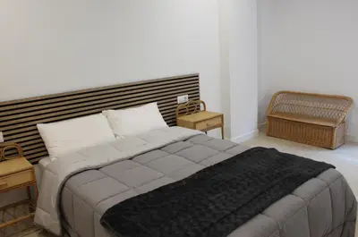 a bedroom with a large bed and two night stands at XELIÑA c in A Estrada
