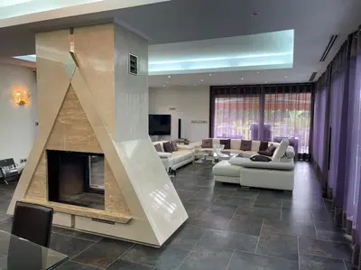 a living room with couches and a fireplace at Villa las palmeras