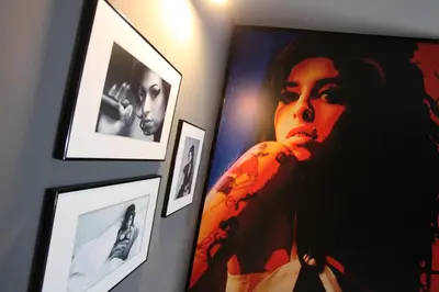 a wall with framed pictures of a woman at Hotel Rock Star in Taboadela