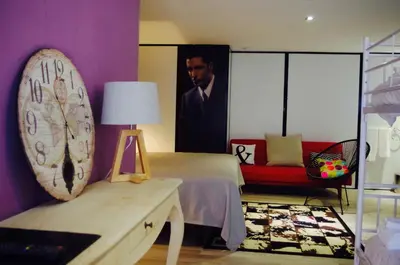 a bedroom with a bed and a picture of a man at Hotel Rock Star in Taboadela