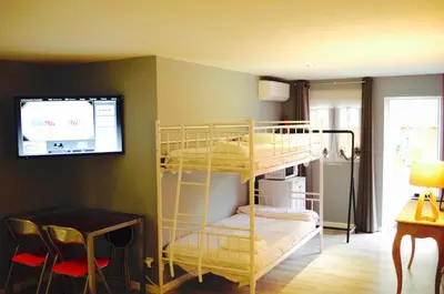 a room with two bunk beds and a tv at Hotel Rock Star in Taboadela