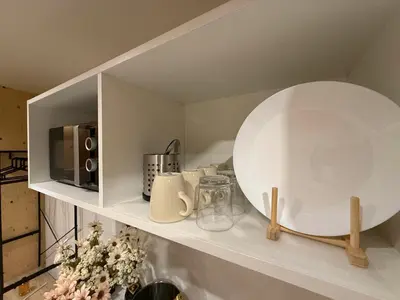 a bedroom with a white bed and a television at Cabañas Camiño do Mar in Foz