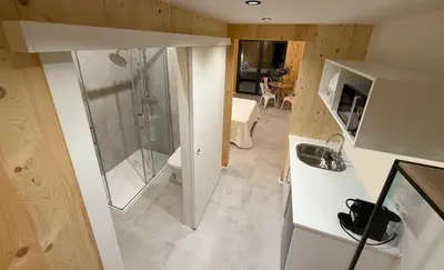 a view of a room with a sink and a bedroom at Cabañas Camiño do Mar in Foz