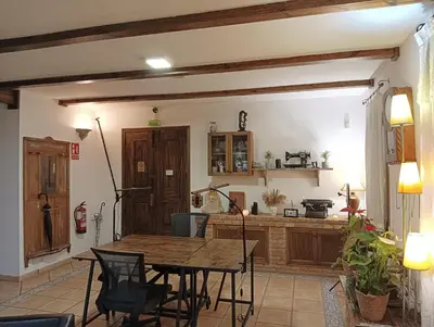 a kitchen with a wooden table in a room at Rural Coliving in Pontevedra