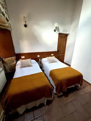 a room with two beds in a room at As Casiñas Bed & Breakfast Porto de Bois in Palas de Rei