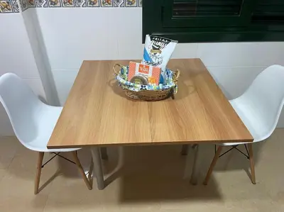 a table with a basket on it with two chairs at As Caldas de Mauro in Caldas de Reis