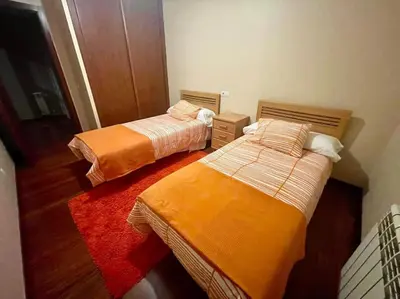 a room with two beds in a room at As Caldas de Mauro in Caldas de Reis