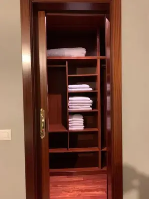 a wooden door with a closet with folded towels at As Caldas de Mauro in Caldas de Reis