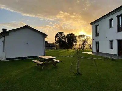 a picnic table in a yard next to a building at La Curtía del Neto in El Franco