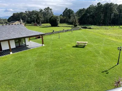 a park with a picnic table in the grass at La Curtía del Neto in El Franco