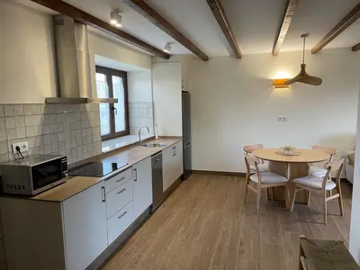 a kitchen with a table and a dining room at La Curtía del Neto in El Franco