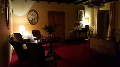 a living room with a table and chairs at Pazo Casa Solariega de Cervantes in San Román