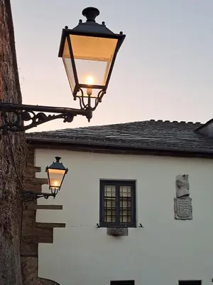 a street light on the side of a white building at Pazo Casa Solariega de Cervantes in San Román