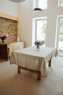 a kitchen with a table with a vase of flowers on it at Casa de Covés in Puentedeume