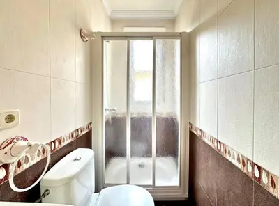 a bathroom with a toilet and a window at Carmela House in Melide