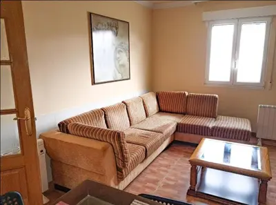 a living room with a couch and a table at Carmela House in Melide