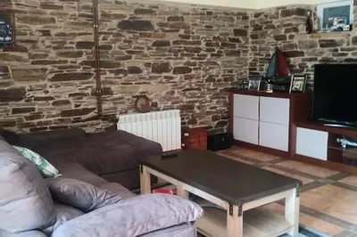 a living room with a couch and a table at Casa Viqueira in Foz