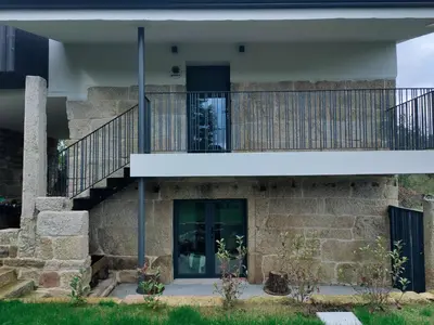 an external view of a stone house with a staircase at Casa Velasca in Mesiego
