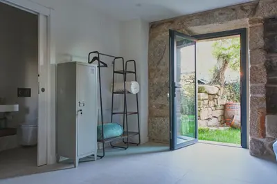 a room with a ladder next to a sliding glass door at Casa Velasca in Mesiego