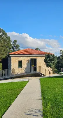 a building with a walkway in front of a yard at Casa Velasca in Mesiego