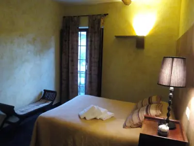 a bedroom with a bed with a lamp and a chair at La Searila in Seares
