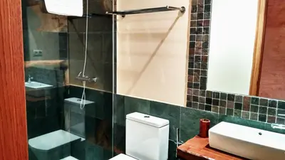 a bathroom with a toilet and a sink and a mirror at La Searila in Seares