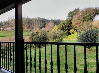 a balcony with a view of a field and trees at La Searila in Seares