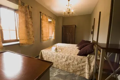 a bedroom with a bed and a table at La Searila in Seares