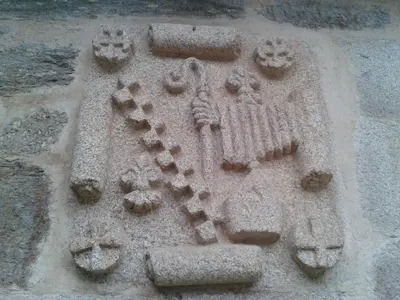 a stone sculpture of an owl on the side of a building at La Posada de Pedrazales in Pedrazales