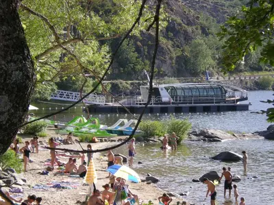 a group of people on a beach near the water at La Posada de Pedrazales in Pedrazales