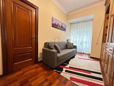 a living room with a couch in front of a door at Balcón da Habana in Ourense